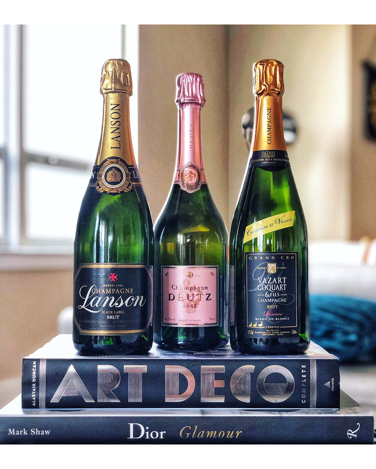 Photo of 3 bottles of champagne with books